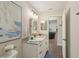 Another bathroom view showing a white vanity, decorative countertop, and updated lighting fixture at 1513 Loretta Ct, Brandon, FL 33511