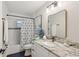 Bathroom features a white vanity, attractive countertop, framed mirror, and tub with tiled wall at 1513 Loretta Ct, Brandon, FL 33511