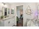 Bathroom with granite counters, modern fixtures, and an adjacent bedroom view at 1513 Loretta Ct, Brandon, FL 33511