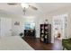 Cozy bedroom with hardwood floors, TV, and a view into the bathroom at 1513 Loretta Ct, Brandon, FL 33511