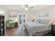 Bright bedroom featuring a comfortable bed, hardwood floors, and access to the outdoors at 1513 Loretta Ct, Brandon, FL 33511