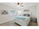 Bright bedroom with a ceiling fan, large window, and coastal themed decor at 1513 Loretta Ct, Brandon, FL 33511