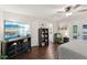 Spacious bedroom with dark hardwood floors and a TV atop a modern cabinet at 1513 Loretta Ct, Brandon, FL 33511