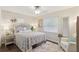 Comfortable bedroom featuring a large window, side table, and decorative bedding at 1513 Loretta Ct, Brandon, FL 33511