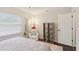 Bedroom features a large window, decorative shelving, and chair with soft rug at 1513 Loretta Ct, Brandon, FL 33511