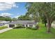 Attractive single-story home with lush landscaping and mature trees adds to the curb appeal at 1513 Loretta Ct, Brandon, FL 33511