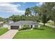 Charming single-story home with well-manicured lawn and mature trees enhance curb appeal at 1513 Loretta Ct, Brandon, FL 33511