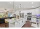 Open concept kitchen with island, stainless steel appliances, and hardwood floors at 1513 Loretta Ct, Brandon, FL 33511