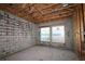 Interior of a room with concrete walls, wood studs, and two windows overlooking the water at 1559 Running Tide Pl, Sarasota, FL 34240