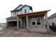 New construction of a two-story home with concrete block exterior and large front porch at 1559 Running Tide Pl, Sarasota, FL 34240