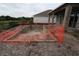 In-ground pool under construction, surrounded by dirt and orange safety fencing, backyard at 1559 Running Tide Pl, Sarasota, FL 34240