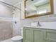 Bathroom featuring a vanity with a solid surface countertop and tile shower with showerhead at 1610 Sanderling Ct, Brandon, FL 33511
