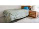 Carpeted bedroom with a side table, lamp and natural light from the window at 1610 Sanderling Ct, Brandon, FL 33511