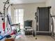 Bright room featuring a treadmill, exercise equipment and natural light at 1610 Sanderling Ct, Brandon, FL 33511