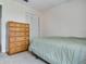Carpeted bedroom with a chest of drawers, closet, and natural light from the window at 1610 Sanderling Ct, Brandon, FL 33511