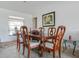 Elegant dining room with a wood table, ornate chairs, and natural light from the window at 1610 Sanderling Ct, Brandon, FL 33511