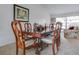 Elegant dining room with a wood table, ornate chairs, and natural light from the window at 1610 Sanderling Ct, Brandon, FL 33511