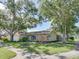 Charming single-story home with mature trees and a lush, well-maintained front yard at 1610 Sanderling Ct, Brandon, FL 33511