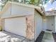 Attached two-car garage with stone accents and a convenient front entry at 1610 Sanderling Ct, Brandon, FL 33511