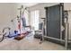 Bonus room filled with fitness equipment including treadmill, weight machine and free weights at 1610 Sanderling Ct, Brandon, FL 33511