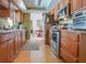 Functional kitchen with wood cabinets, stainless appliances, and plenty of counter space at 1610 Sanderling Ct, Brandon, FL 33511