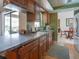 Practical kitchen featuring wood cabinets, a breakfast bar, and easy access to the outdoor patio at 1610 Sanderling Ct, Brandon, FL 33511