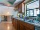 Well-lit kitchen with a double sink, wood cabinets, and a large window overlooking the backyard at 1610 Sanderling Ct, Brandon, FL 33511