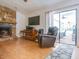 Cozy living room featuring a stone fireplace and sliding glass doors to the lanai at 1610 Sanderling Ct, Brandon, FL 33511