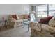 Comfortable living room featuring floral sofas and a glass table by a bright window at 1610 Sanderling Ct, Brandon, FL 33511