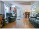Open-concept living room featuring a breakfast bar, wood floors, and comfortable seating area at 1610 Sanderling Ct, Brandon, FL 33511