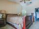 Bedroom featuring a ceiling fan, neutral colors, and an ensuite bathroom at 1610 Sanderling Ct, Brandon, FL 33511
