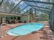 Inviting screened-in pool area with outdoor seating and backyard access at 1610 Sanderling Ct, Brandon, FL 33511