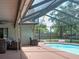 Screened-in pool with inviting outdoor seating and beautiful backyard views at 1610 Sanderling Ct, Brandon, FL 33511