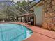 Stunning screened-in pool with a stone-accented exterior and ample deck space at 1610 Sanderling Ct, Brandon, FL 33511