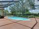 Beautiful screened-in pool area with a spacious deck and lush backyard at 1610 Sanderling Ct, Brandon, FL 33511