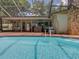 Inviting screened pool area with outdoor seating and serene backyard views at 1610 Sanderling Ct, Brandon, FL 33511