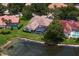 Aerial view showcases the home's pool, screened enclosure, and pond-front location at 17807 Arbor Greene Dr, Tampa, FL 33647