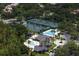 Aerial view of community featuring tennis courts, pool, clubhouse, and mature trees at 17807 Arbor Greene Dr, Tampa, FL 33647