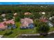 Aerial showcases a home with a screened-in pool, lush lawn, and waterfront views at 17807 Arbor Greene Dr, Tampa, FL 33647