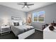 Bright bedroom features a ceiling fan, modern decor, and a large window for plenty of natural light at 17807 Arbor Greene Dr, Tampa, FL 33647