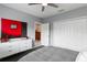 This bedroom features a ceiling fan, closet, and minimalist decor with cool colors at 17807 Arbor Greene Dr, Tampa, FL 33647