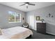 Bedroom with a ceiling fan, a window with backyard views, and a dresser for storage at 17807 Arbor Greene Dr, Tampa, FL 33647