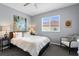 Cozy bedroom with neutral walls, a ceiling fan, and a window with views of the neighborhood at 17807 Arbor Greene Dr, Tampa, FL 33647