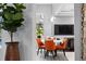 Small breakfast nook featuring orange chairs, stylish decor, and connection to living space at 17807 Arbor Greene Dr, Tampa, FL 33647