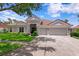Charming single-story home with tile roof, well-manicured lawn and a three-car garage at 17807 Arbor Greene Dr, Tampa, FL 33647
