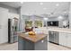 Open-concept kitchen with stainless steel appliances and a view of the living area and pool at 17807 Arbor Greene Dr, Tampa, FL 33647