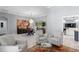 Spacious living room with modern furnishings, decorative chandelier and view to patio at 17807 Arbor Greene Dr, Tampa, FL 33647