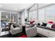 This well-lit living room boasts views of the pool and lake with a built-in seating area and modern decor at 17807 Arbor Greene Dr, Tampa, FL 33647