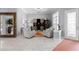Bright living room featuring marble floors, modern furniture and a wine fridge at 17807 Arbor Greene Dr, Tampa, FL 33647