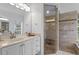 Updated main bathroom featuring a glass enclosed shower with a seat and a double sink vanity at 17807 Arbor Greene Dr, Tampa, FL 33647